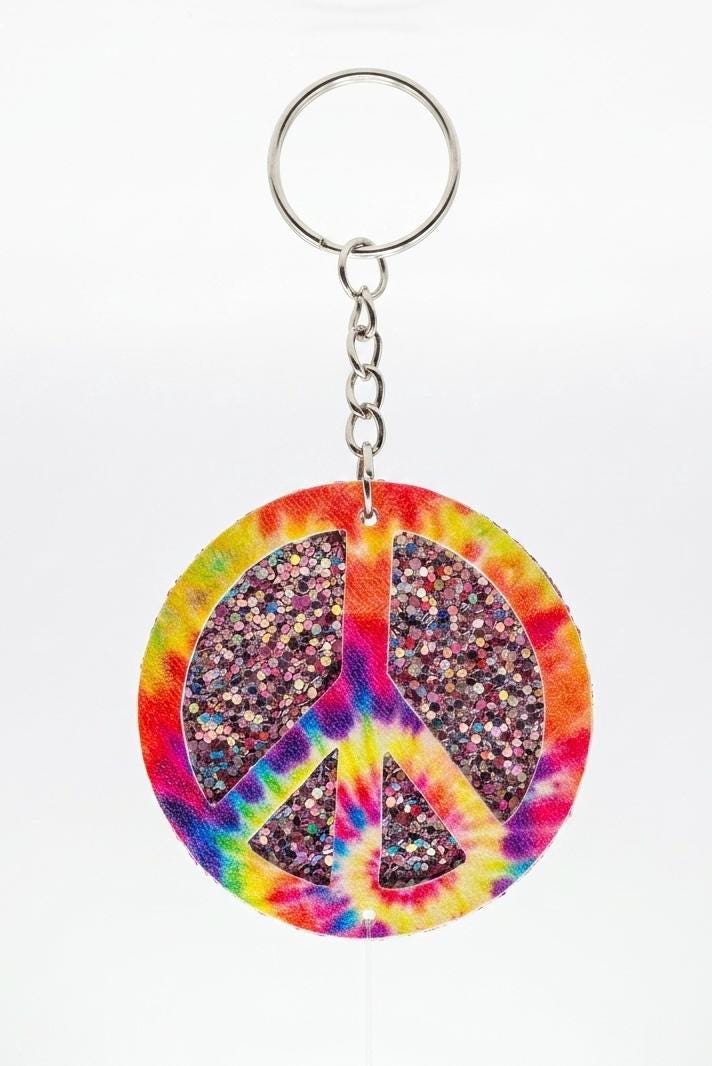 Keychain with tie-dye peace sign design on a white background