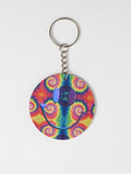 Colorful tie-dye smiley face keychain on a white background