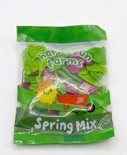 Packaged spring mix with 'Harvest Farms' branding on a white background